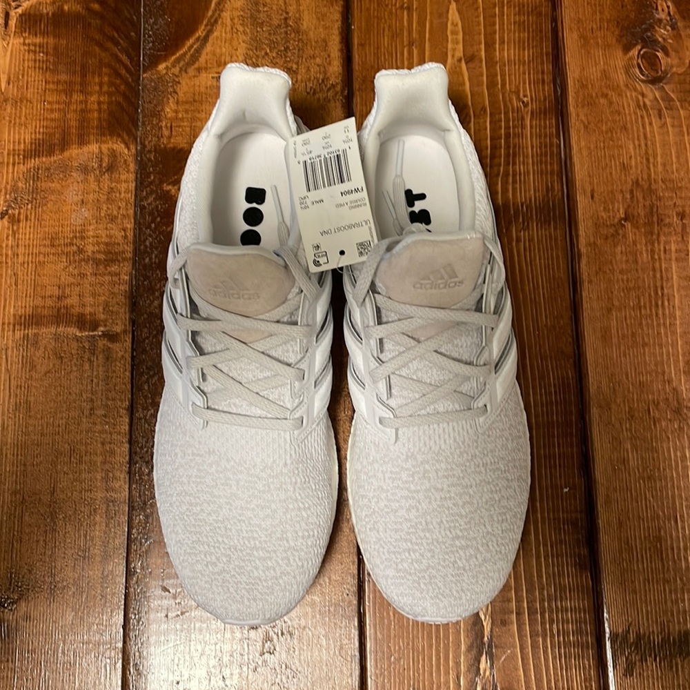 This is a pair of new  with tags adidas ultraboost shoes in cloud white.